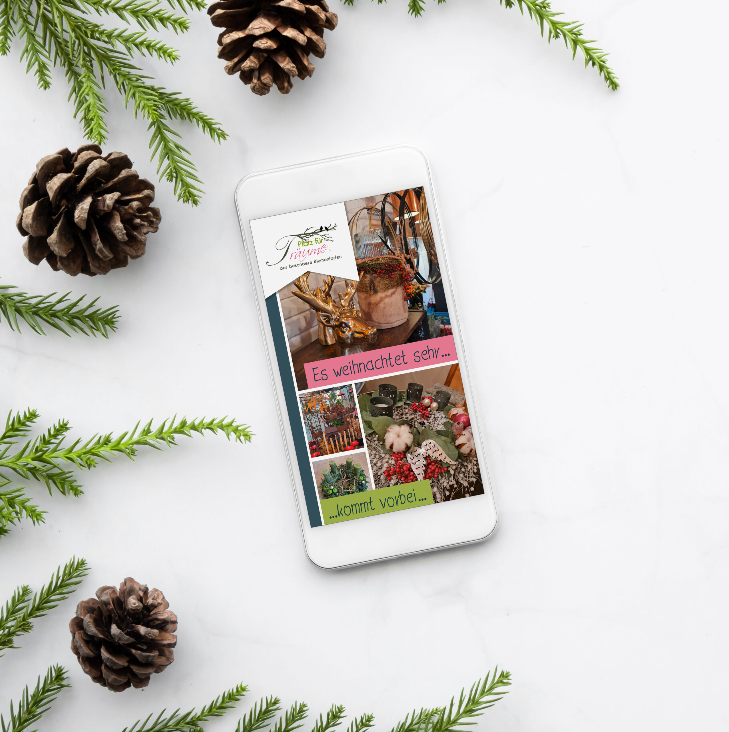 Smartphone with blank screen is on top of white marble table with Christmas decorations. Top view with copy space, flat lay.